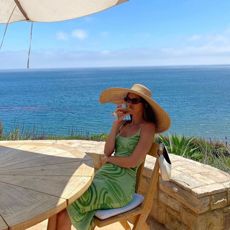 Image may contain: Clothing, Apparel, Wood, Human, Person, Hat, Sun Hat, Sunglasses, Accessories, Accessory, and Water